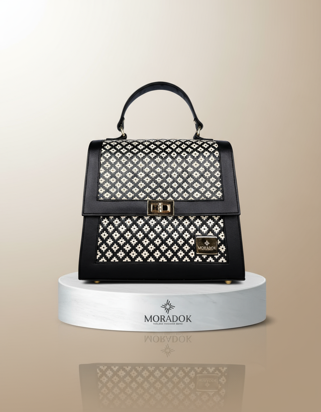 Black handbag with white pattern on a beige background, featuring the Moradok brand.